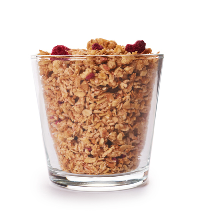 homemade granola with dried fruits in glass cup isolated on white background.の写真素材