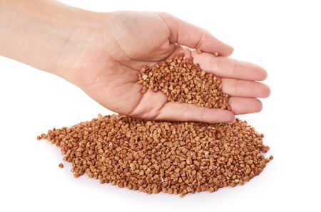 healthy buckwheat grains in hand isolated on white background.の写真素材