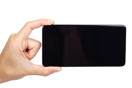smart phone with blank screen in hand isolated on white background, big mobile, black cellphone, 5.5 inch communicator.の写真素材