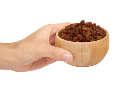 delicious and healthy raisins in wooden bowl isolated on white background, healthy sweet snack.の写真素材