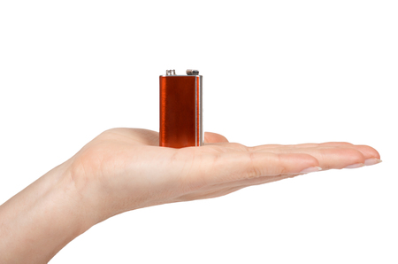 9V battery, nine volt power cell in hand. Isolated on white background.の写真素材