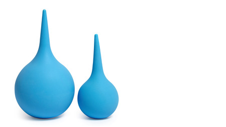 Blue enema syringe, isolated on white background. Copy space, template.の写真素材