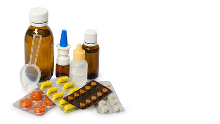 Bottles with medicine, nasal spray. Cough syrup, antipyretic syrup and nose drops on white background. Medication for cold treatment, copy space, template.の写真素材
