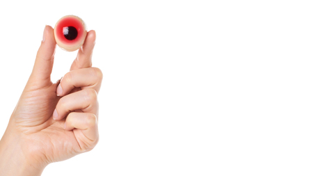 Halloween spooky jelly eye in hand isolated on white background. copy space, template.の写真素材