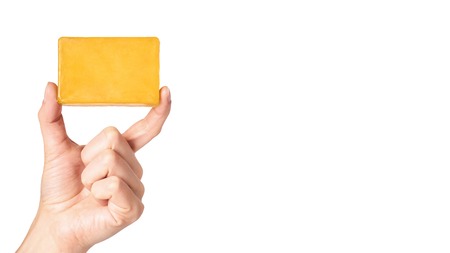 natural handmade soap bar in hand isolated on white background. copy space, template.の写真素材