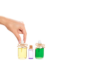 eco aroma oil bottle in hand isolated on white background. copy space, template.