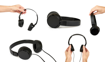 Set of different Black headphones in hand isolated on white background.の写真素材