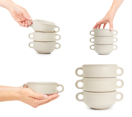 set of different female hand holding ceramic bowl for soup . Isolated on white background.の写真素材