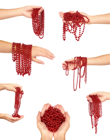 set of different Cristmas decoration, ceramic red ball chain with hand isolated on white background. New Year object, Mardi Gras beads.の写真素材