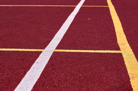 Decorative rubberized Jogging coating at the street stadium in outdoor with white line. Sport...