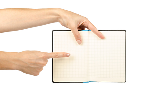 Opened black notebook with hand, isolated on white background.の写真素材