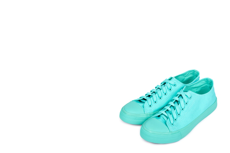 Turquoise rubber sneakers, casual footwear isolated on white background, copy space template.の写真素材