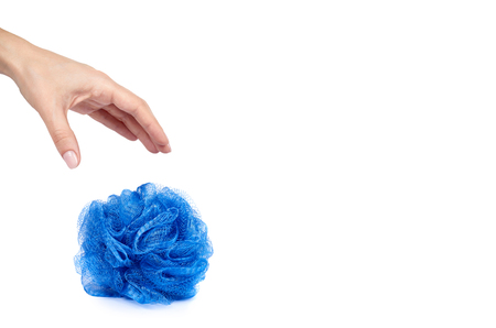 Blue bath sponge with hand isolated on white background, copy space template.の写真素材