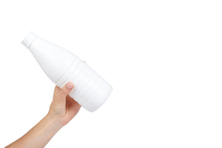 White plastic milk bottle with hand isolated on white background, copy space template.