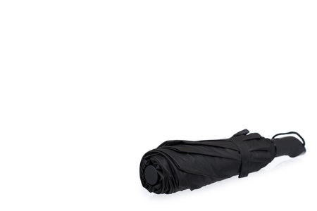 Single closed black umbrella isolated on a white background, copy space templateの写真素材