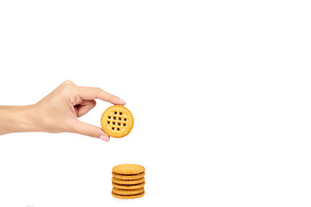 Cookies with cream filling with hand isolated on white background, copy space templateの写真素材