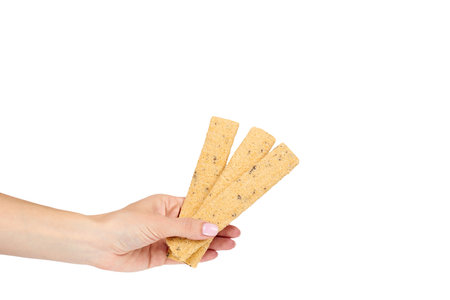 Crispy cookies with chocolate fill with hand isolated on a white background, copy space template.