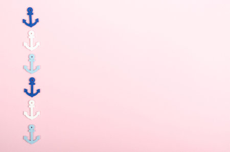 Flat lay concept of summer travel vacations, top view of anchors a on pastel pink background with copy space in minimal style, greeting card template.の写真素材