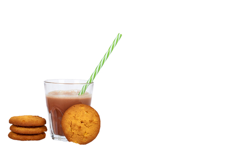 Glass of chocolate milk cocoa and straw with homemade cookies isolated on white background, copy space template.の写真素材