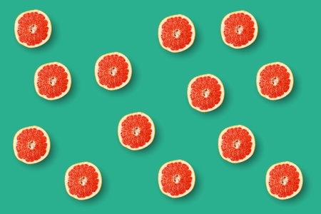 Ripe grapefruit slice pattern on turquoise background.