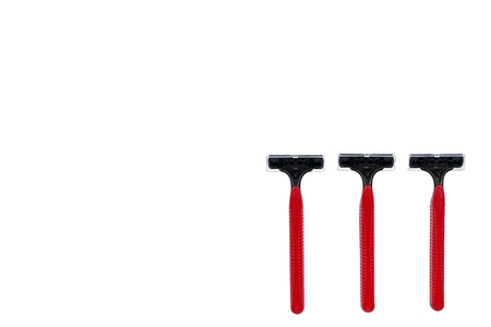 Red disposable shaving razor isolated on white background, copy space templateの写真素材