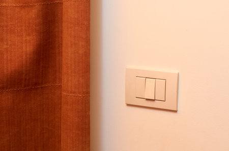 white light switch on the wall in the room.