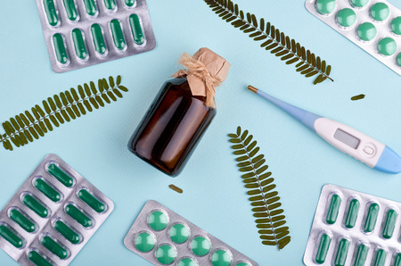 Medicine background - pharmacy. Pharmaceutical pills on blue backdrop. Flat lay imageの写真素材