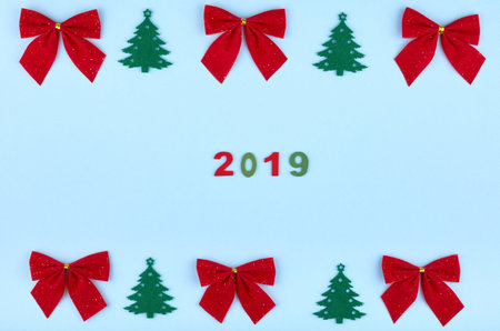 New Year 2019 composition with number, pine tree and red ribbon. Christmas concept background. Flat...