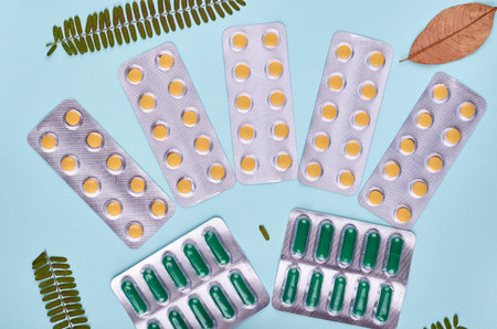 Medicine background - pharmacy. Pharmaceutical pills on blue backdrop. Flat lay image.