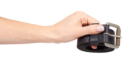 Hand with dark leather belt with metal buckle, male accessory. Isolated on white background