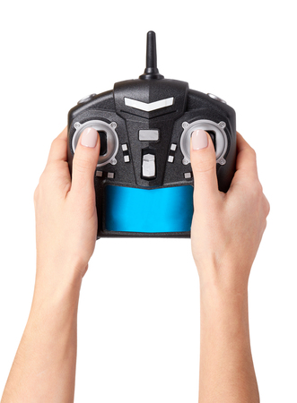 Hand with black remote control for drone, RC with antenna. Isolated on white backgroundの写真素材
