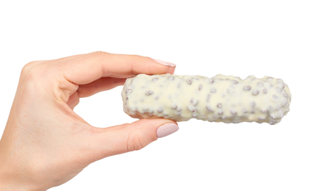 Hand with healthy granola, energy, sport, breakfast and protein bar. Isolated on white backgroundの写真素材