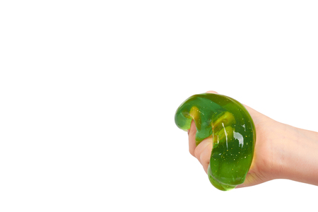 kid playing green slime with hand, transparent toy. Isolated on white background. Copy spaceの写真素材