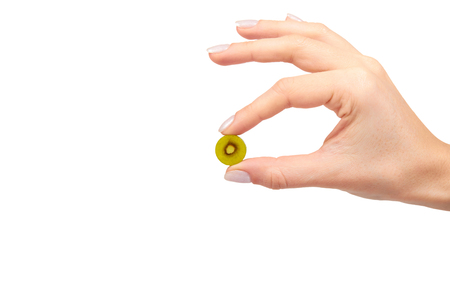Hand with colored round candy, sugar lollipop. Isolated on white background. Copy spaceの写真素材