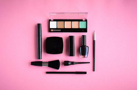 Different makeup products composition on pink background, flat lay and top view photoの写真素材