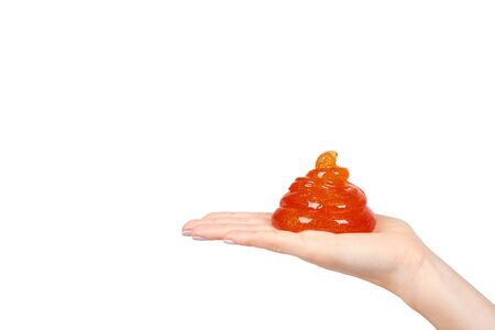kid playing orange slime with hand, transparent toy. Isolated on white background. Copy space templateの写真素材