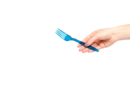 Hand with blue plastic fork, disposable utensil. Isolated on white background. Copy space template