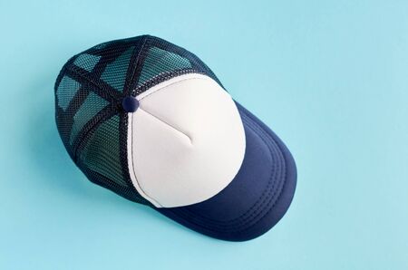 Baseball cap on blue background composition. Flat lay and top view photoの写真素材