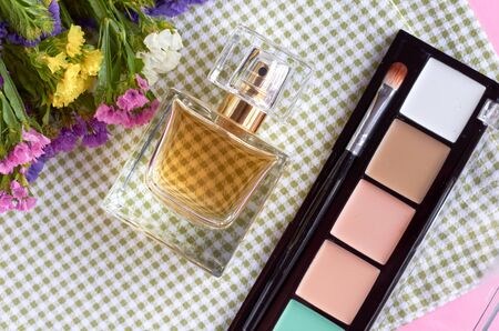 Perfume bottle with flowers on napkin background composition. Flat lay and top view photoの写真素材
