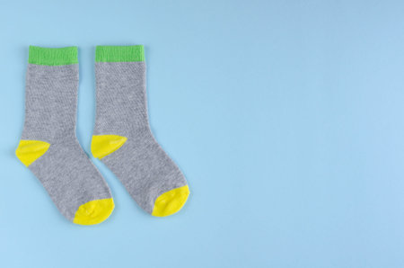 Kids socks composition on blue background. Flat lay, layout and tabletop mockup with copy space.