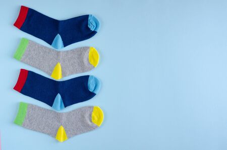 Kids socks composition on blue background. Flat lay, layout and tabletop mockup with copy space.の写真素材