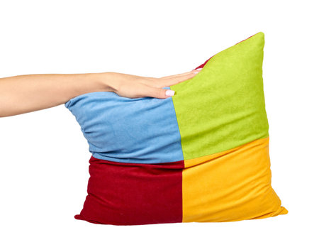 Hand with decorative square pillow, multicolored cloth, soft and puffy. Isolated on white background.の写真素材