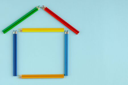 Colored pencils composition on blue background. Flat lay, layout and tabletop mockup with copy space.の写真素材