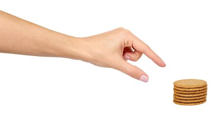 Hand with round cookies with whole wheat. Healthy snack. Isolated on white background.の写真素材
