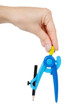 Hand with blue plastic stationery compass for kids. School supply. Isolated on white background.の写真素材