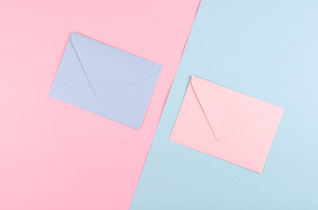 Blue paper envelope composition on pink background. Flat lay, layout and tabletop mockup with copy space.の写真素材