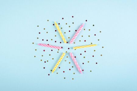 Colored candles composition on blue background, party and celebration decoration. Flat lay, layout and tabletop mockup with copy space.の写真素材