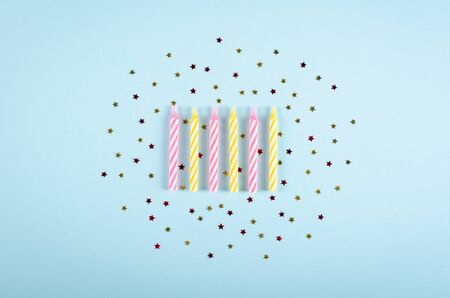 Colored candles composition on blue background, party and celebration decoration. Flat lay, layout and tabletop mockup with copy space.の写真素材