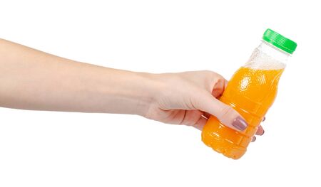 Hand with orange juice in little plastic bottle for kids. Healthy drink. Isolated on white background.の写真素材