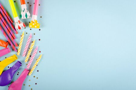 Colored confetti and air balloons composition on blue background, party and celebration decoration. Flat lay, layout and tabletop mockup with copy space.の写真素材